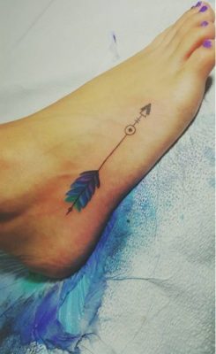 woman's vibrant feather foot tattoo