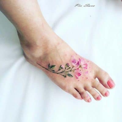 woman's vibrant floral foot tattoo