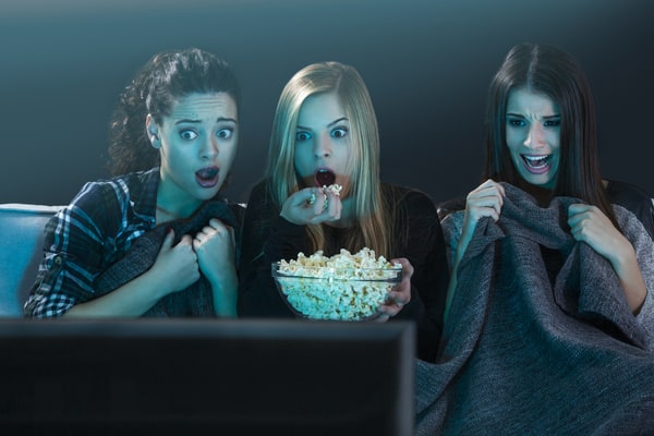 Teenage girls binge-watching movies Halloween movies