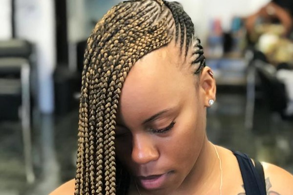 Check out the classic parted lemonade braids hairstyle.