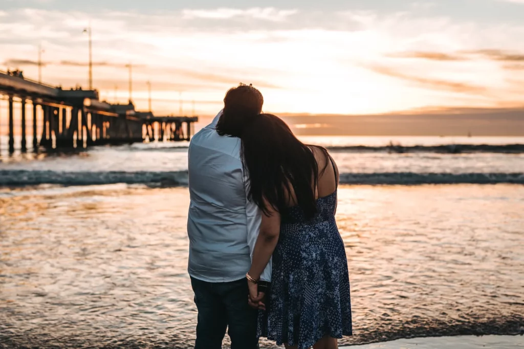 Couples beside the sea at sunset