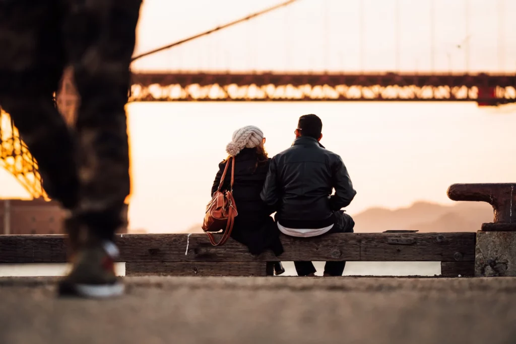 Couples siting beside the river