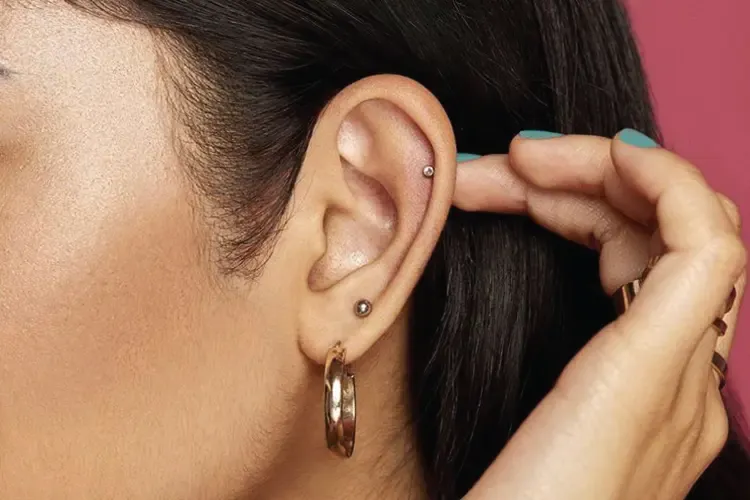 Side profile view of a girl with Curated Ear Piercings